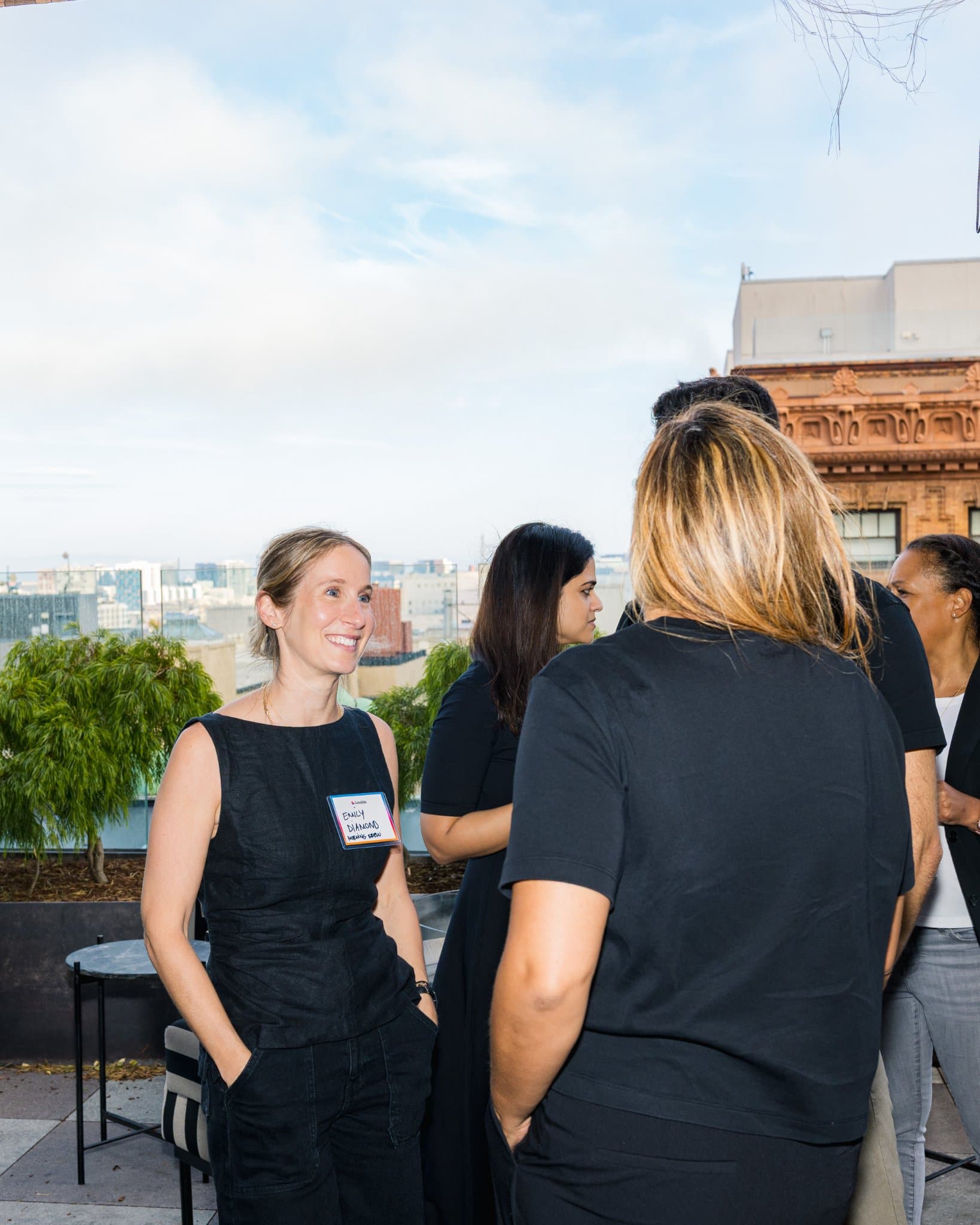 Guests talking on the rooftop terrace on an overcast afternoon at Lovable's When Everyone Can Build panel in San Francisco by JY Studio