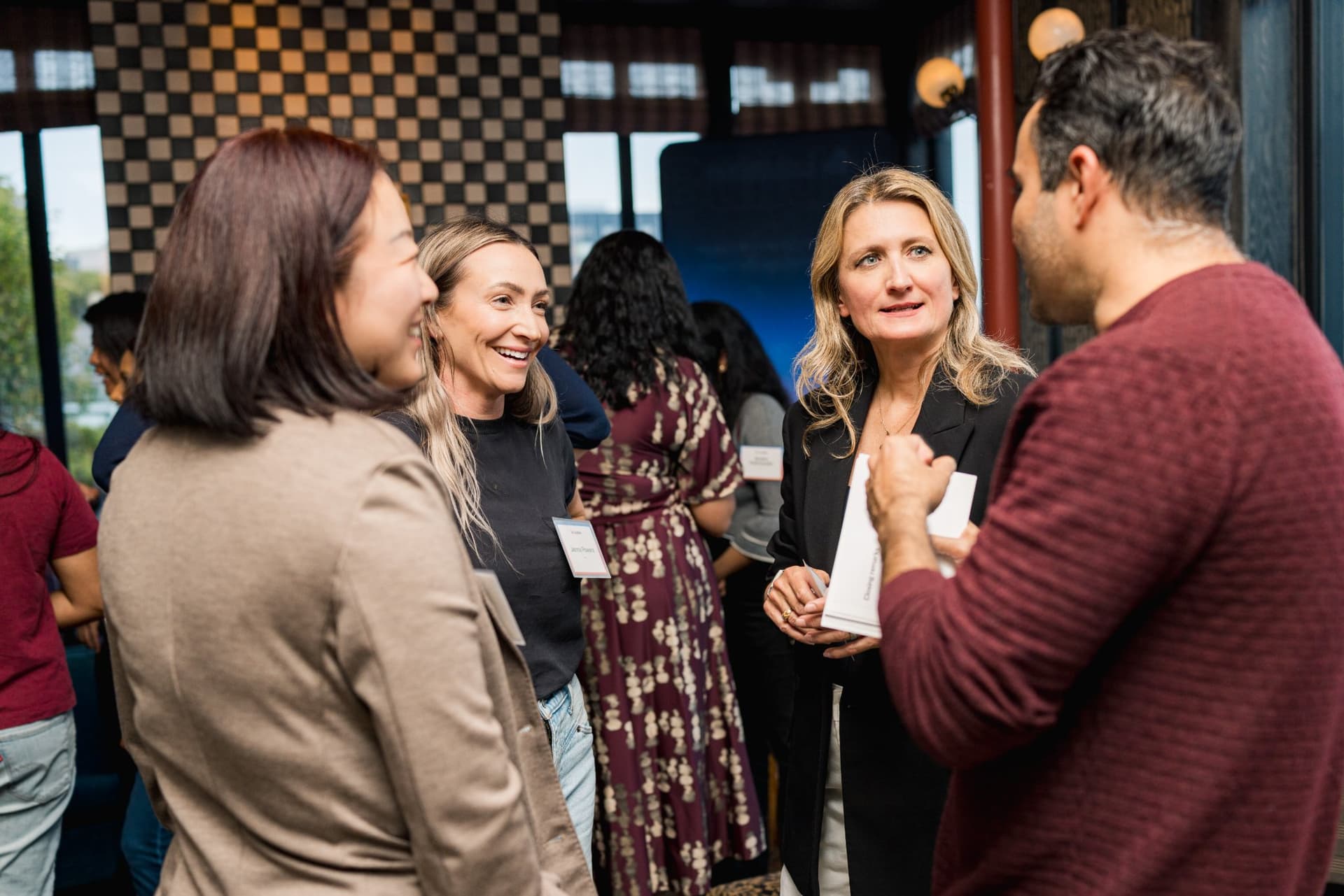 Group of guests in conversation during the reception at Lovable's When Everyone Can Build panel in San Francisco by JY Studio