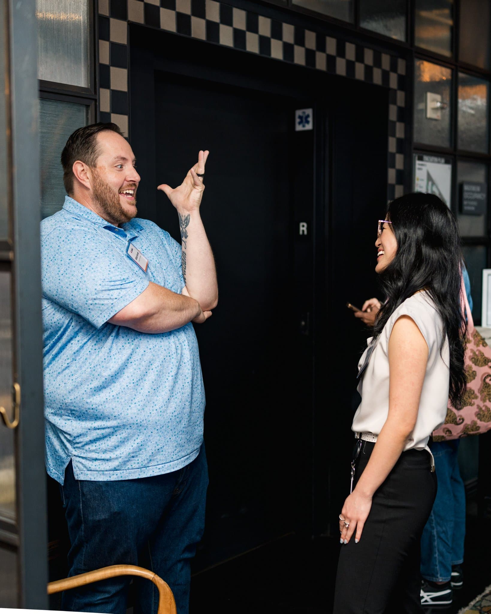 Guest gesturing animatedly in conversation at Lovable's When Everyone Can Build panel in San Francisco by JY Studio