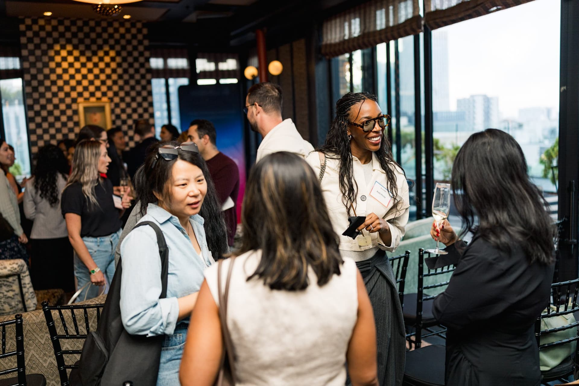 Guests mingling in the lounge during the networking reception at Lovable's When Everyone Can Build panel in San Francisco by JY Studio