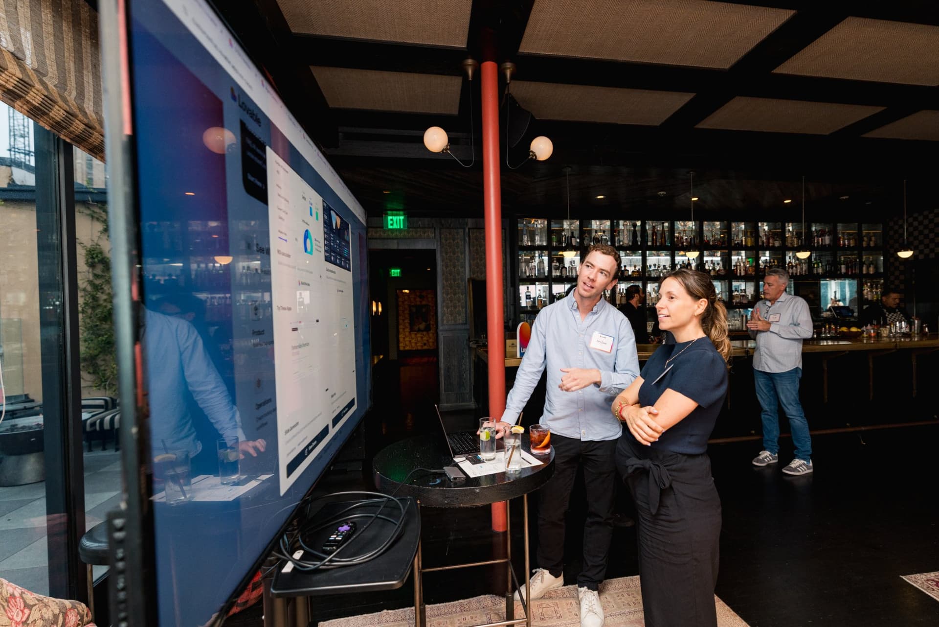 Guests gathered around a large demo screen in the lounge at Lovable's When Everyone Can Build panel in San Francisco by JY Studio