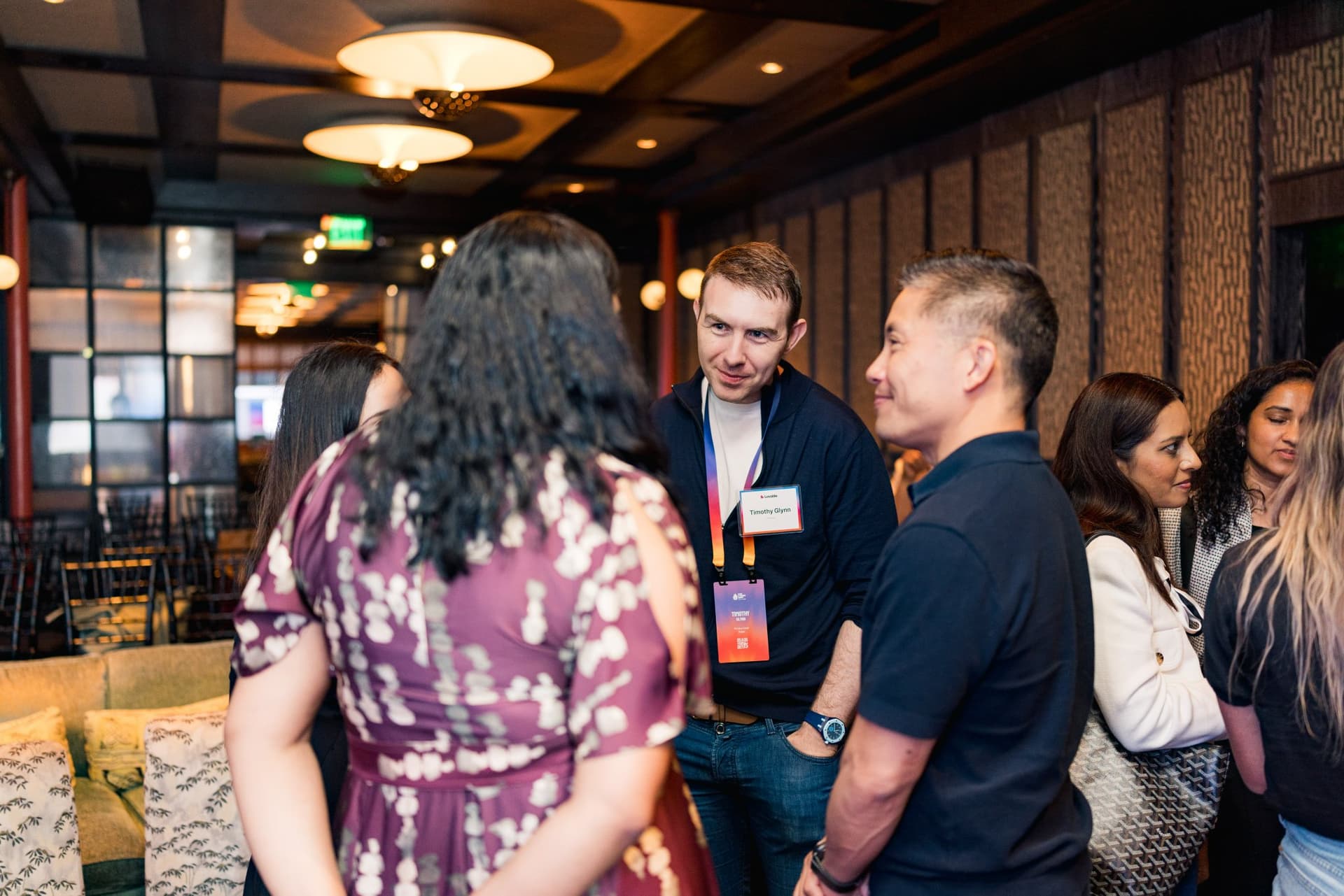 Group of guests chatting during the networking reception at Lovable's When Everyone Can Build panel in San Francisco by JY Studio