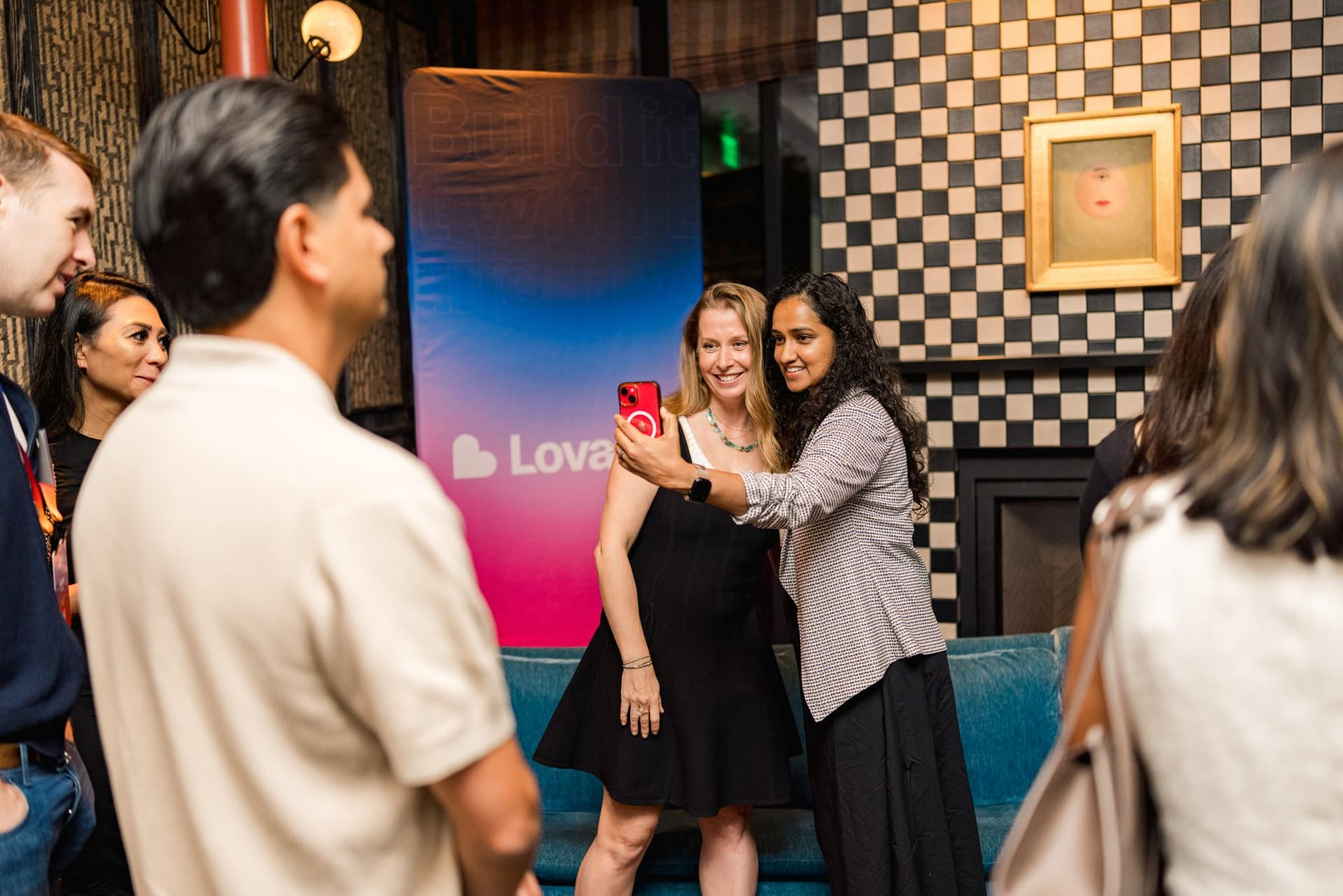 Guests taking a selfie in front of the Lovable banner at Lovable's When Everyone Can Build panel in San Francisco by JY Studio