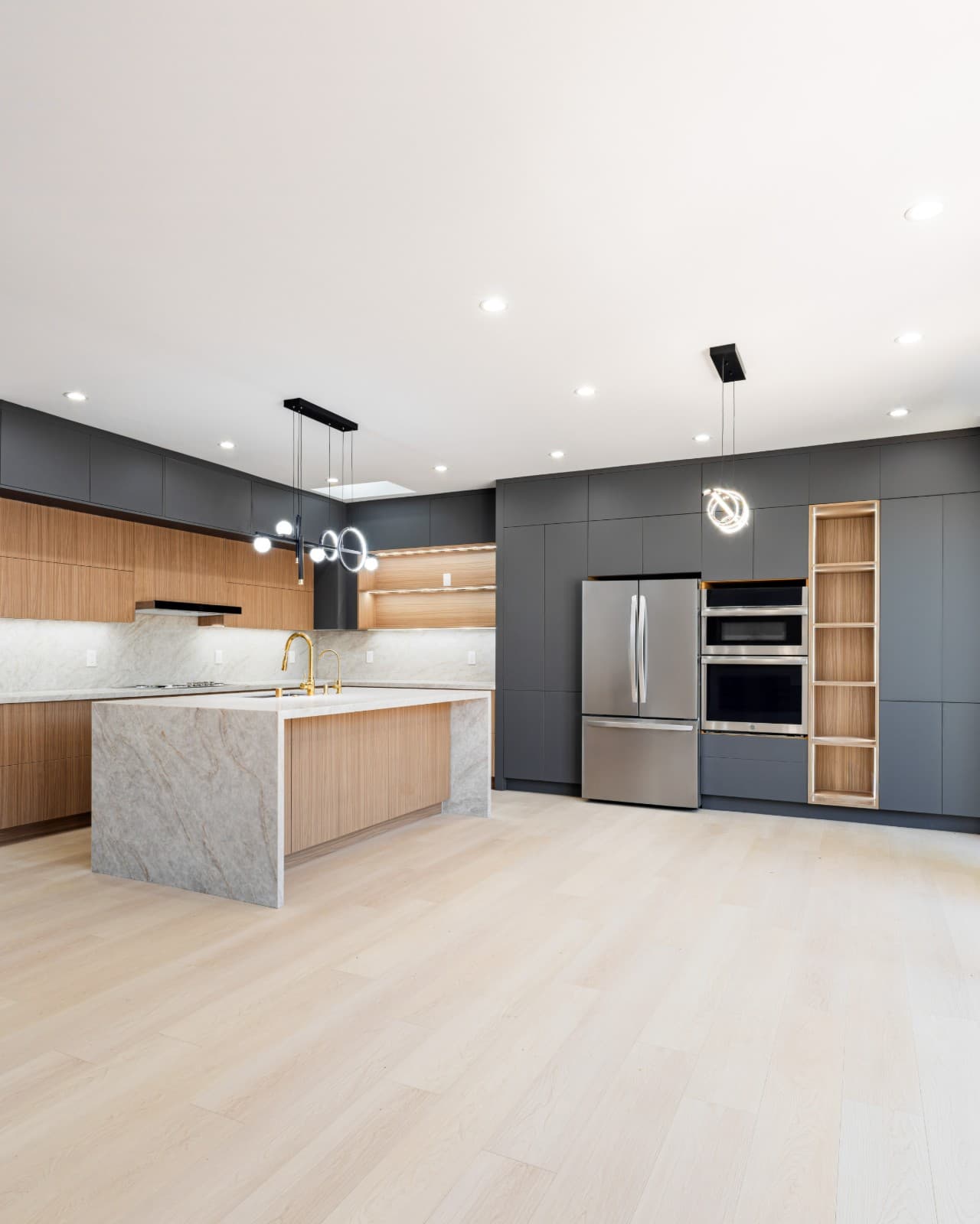 Modern kitchen lighting design in contemporary Sunnyvale Bay Area home by Kassa Kitchen and Bath by JY Studio